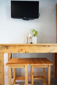 沙努尔Louto Dmell Guesthouse的一张木桌,上面配有电视