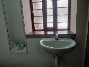 库斯科Anais y Nicolas Hostel Cusco的浴室设有水槽、窗户和镜子