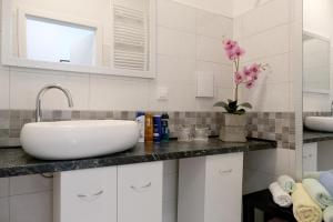 萨格勒布Main Square Oval Apartment的白色的浴室设有水槽和镜子
