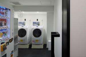 名古屋hotel androoms Nagoya Fushimi的洗衣房配有4台洗衣机和冰箱