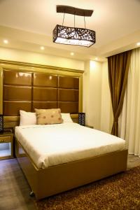 十月六日城Villa 14 Suites的一间卧室配有一张大床和大床头板