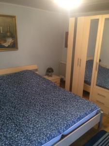 MontenauHaus Pauline的一间卧室配有一张带蓝色床罩的床