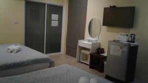 盼武里山景度假酒店的一间卧室配有床、水槽和镜子
