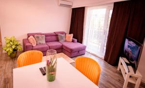 北马马亚-讷沃达里Nairi Apartment的客厅配有紫色沙发和桌子
