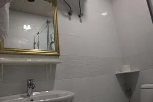 巴统32精品酒店的白色的浴室设有镜子和水槽