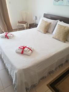 马尔萨什洛克White Pearl Apart 5的一张白色的大床,上面有两条白色毛巾