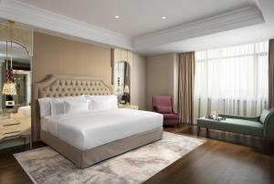 伊斯坦布尔Barceló Istanbul的卧室配有白色的床和绿色椅子