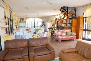 维多利亚Il Dunnè的客厅配有棕色皮沙发和桌子