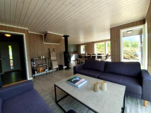 OffersøyaExplorers Cabin Lofoten的客厅配有紫色沙发和桌子