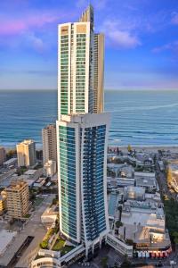 黄金海岸假日H公寓式酒店的一座城市,两座高楼毗邻大海