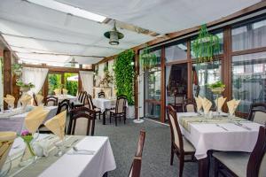 普热梅希尔Pokoje Gościnne Murowanka的餐厅设有白色的桌椅和窗户。