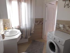 特拉佩托SOPHIA Appartament的一间带洗衣机和水槽的浴室