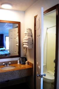 新奥尔良市韦斯特瓦德汽车旅馆的一间带水槽、镜子和卫生间的浴室