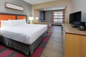 达拉斯达拉斯爱之田拉金塔旅馆及套房的配有一张床和一台平面电视的酒店客房