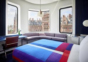 伦敦The Standard London的一间卧室配有一张床、一张沙发和窗户。