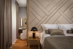 斯普利特Five Elements Luxury Rooms的一间卧室配有一张大床和木制床头板