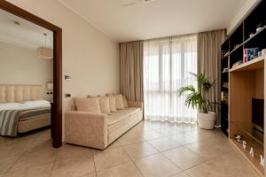 锡耶纳安吉赫尔酒店式公寓的一间带沙发、床和窗户的卧室
