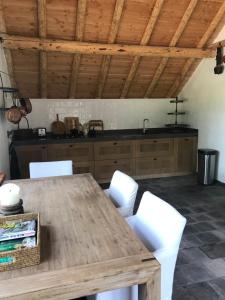 埃姆斯特The Barn的厨房配有木桌和白色椅子