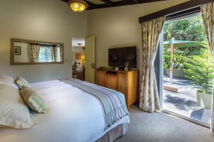 马丘比丘Sanctuary Lodge, A Belmond Hotel, Machu Picchu的一间卧室设有一张床和一个滑动玻璃门