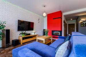 斯蒂格纳Lawendowy Zakatek的客厅配有蓝色的沙发和电视