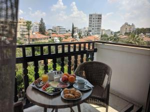 尼科西亚尼科西亚罗德斯公寓式酒店的阳台上的早餐食品桌