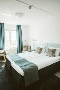 恩厄尔霍尔姆Best Western Valhall Park Hotell的一张大床,位于带蓝色窗帘的房间