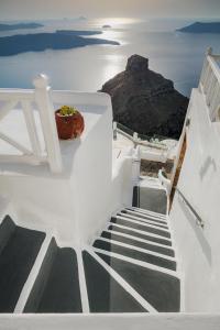 易莫洛林西娅公寓式酒店的楼梯通往大海,有岩石