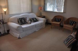 宜野湾市Old American House K-113的客厅配有白色沙发和两把椅子