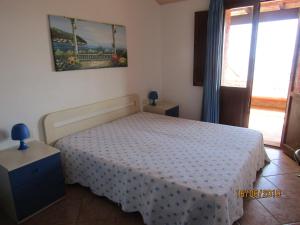 Villetta Sole e Mare di Sardegna a Porto Corallo客房内的一张或多张床位