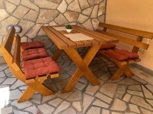 卢什蒂卡Žanjice Luxury Suite的一张木桌和两张椅子坐在桌子旁