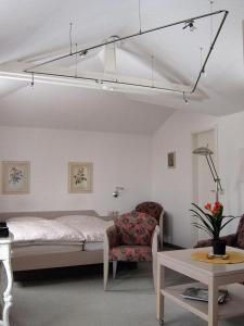 Klein ZickerUns Gartenhus的一间卧室配有一张床、一把椅子和一张桌子