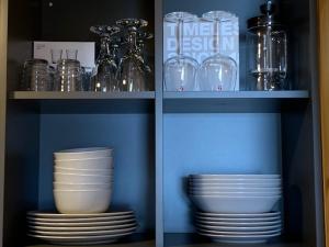 卡斯姆Small Vinter Summer House的装有盘子、碗和玻璃杯的橱柜