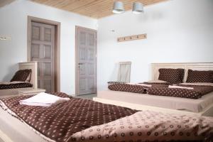 VainutasKaimo turizmo sodyba "Ąžuola"的一间卧室配有两张床和两把椅子