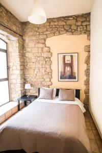 曼雷沙乌尔比公寓的一张大床,位于一个石墙房间内