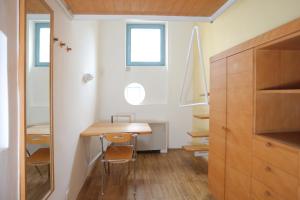卢布尔雅那Hostel Celica的小房间设有木桌和一些窗户