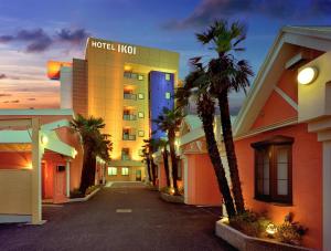 川口市HOTEL IKOI (Adult Only)的一座楼前有棕榈树的酒店