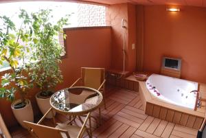 川口市HOTEL IKOI (Adult Only)的带浴缸、桌子和植物的浴室