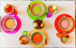 莫诺波利Sisters in Law Guesthouse的一张桌子上放着五颜六色的盘子和水果