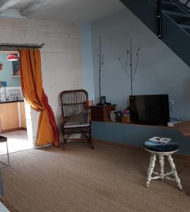 洛什La cordonnerie的客厅配有椅子和电视