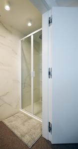 科克赛德Studio Koksijde的玻璃淋浴间,浴室设有大理石墙壁