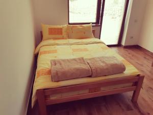利塔尼Sobe Gmitrovic的铺有木地板的客房内的一张小床