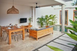 龙目岛库塔Kumbara Villas的客厅配有桌子和浴缸