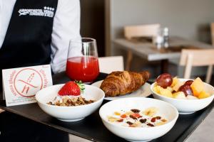 多索博诺维罗那机场会议及休闲酒店的盘子上放着一碗食物和一杯果汁