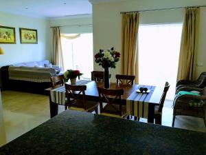 阿尔科斯-德拉弗龙特拉FAIRWAY GARDENS的客厅配有桌椅和沙发