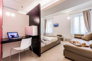 帕尔马萨伏伊酒店的酒店客房配有一张床、一张书桌和一张沙发。