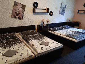 哈拉霍夫Penzion Union Harrachov的两张睡床彼此相邻,位于一个房间里