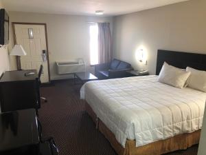 Friona菲瑞纳维旅馆的酒店客房,配有床和沙发