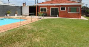 里奥克拉鲁Chácara Vô Orlando的一个带游泳池和房子的后院