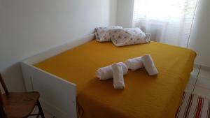 CalhetaAdega do Batista的床上有两条滚毛巾