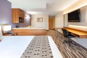 罗宾逊镇匹兹堡机场麦克罗特客栈&套房酒店的配有一张床和一张书桌的酒店客房